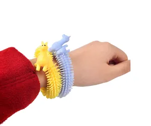 Close-up detail of yellow and blue alpaca stretchy relief bracelets worn on a wrist