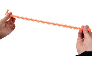 Orange textured dinosaur stretchy noodle fidget toy being pulled to show its high elasticity