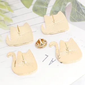 Back view of gold cat-shaped enamel pins showing butterfly clutch and needle set