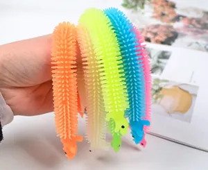 Close-up of colorful stretchy dinosaur sensory toys held in hand for stress relief