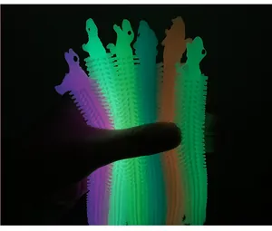 Detailed view of colorful glowing alpaca stretchy noodle stress relief toys in the dark