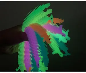 Close-up of glow-in-the-dark dinosaur stretchy fidget toys in various bright colors
