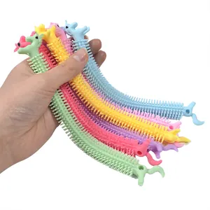 Close-up of colorful unicorn and dinosaur stretchy fidget string toys for stress relief