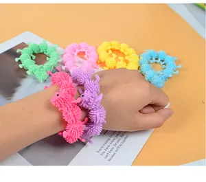 Close-up of colorful stretchy alpaca fidget bracelets worn on a hand for stress relief
