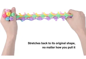 Hands stretching colorful dinosaur and alpaca sensory string fidget toys for stress relief