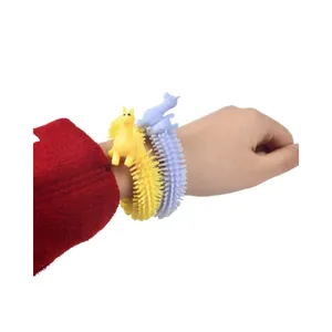 Soft cartoon llama stress relief bracelets worn on wrist, yellow and purple colors.