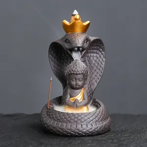Creative ceramic cobra backflow incense burner with golden crown and sitting Buddha figurine