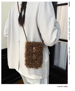Detail view of brown curly faux fur crossbody phone bag worn with grey blazer.