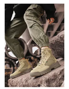 Detailed side view of khaki men's high-top outdoor tactical work boots on rocks
