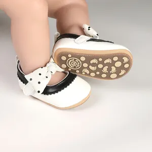 Close-up of baby girl walker shoes with polka dot bow and anti-slip sole