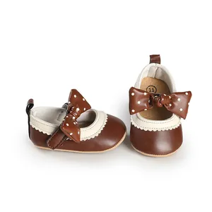 Detailed macro view of brown infant girl walking shoes with a polka dot bow accent