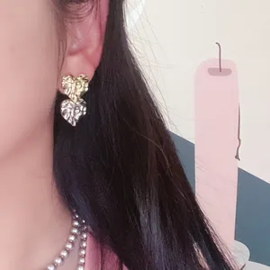 Stylish crumpled heart-shaped contrast color earrings with gold and silver tones