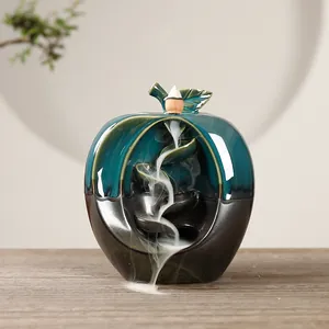 Elegant apple-shaped ceramic backflow incense burner with a sleek teal and black glaze finish