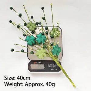 Detailed view of St. Patrick's Day glitter shamrock branch on scale showing 40cm length