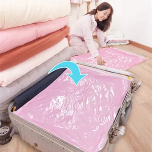 Pink vacuum storage bag for quilts and clothes being packed in a travel suitcase