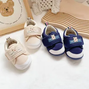 Detailed view of breathable navy and beige baby walking shoes with bear velcro