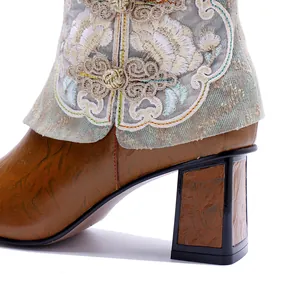 Detailed close-up of retro ethnic ankle boot featuring floral embroidery and a block heel