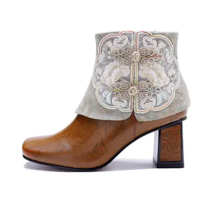 Detailed side view of retro ethnic style real leather ankle boot with floral embroidery