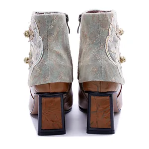 Rear view of retro ethnic handmade leather ankle boots with embroidery and block heels.