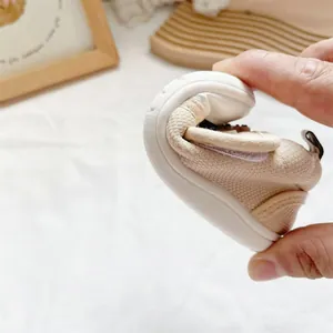 Detailed macro view showing the high flexibility of cream soft sole baby walking shoes