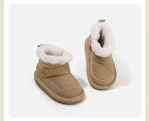 Close-up of children's tan snow boots with cozy white fleece lining and MBX logo