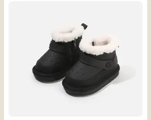 Detailed view of black children's winter snow boots with warm white fleece lining.