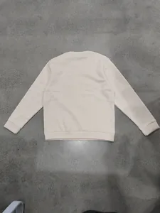 Detailed back view of a heavyweight cream-colored crewneck fleece sweatshirt for men.