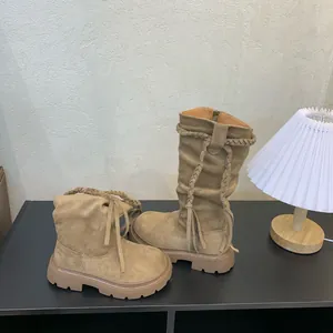 Retro khaki suede mid-calf boots for girls featuring braided strap detail in lifestyle setting