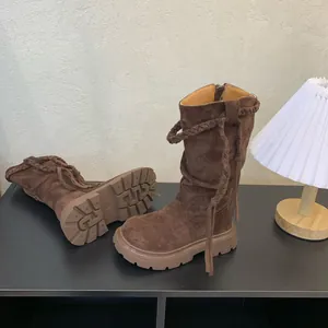 Detailed macro view of girls retro brown suede tall boots featuring non-slip thick rubber soles
