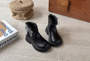 Elegant black children's Martin boots featuring a houndstooth bow and knit ankle detail