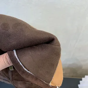 Close-up showing the warm brown fleece lining and soft suede texture of girls high boots