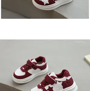Detail view of burgundy and white children sneakers with decorative star pattern