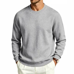 Detailed view of grey crewneck sweatshirt texture and classic loose fit on male model