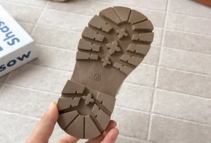 Close-up of the non-slip brown rubber sole of girls' Martin boots with star treads