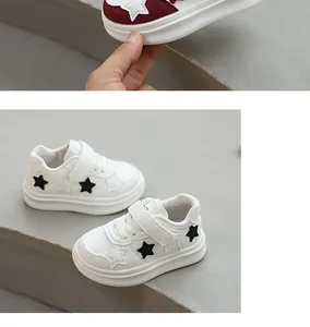 Detailed view of white children's skate shoes with black star patterns