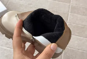 Close-up detail showing the warm black fleece lining inside stylish children's leather boots