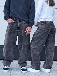 Detailed view of dark grey oversized acid wash jeans showing baggy fit and denim texture