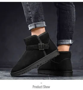 Macro detail of black suede leather snow boots featuring a decorative buckle strap