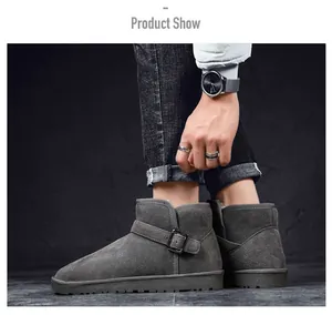 Side view detail of grey suede snow boots featuring a stylish metallic buckle strap.