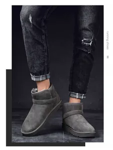 Grey suede snow boots with fur lining and strap detail worn with black jeans