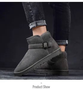 Detailed view of dark grey suede snow boots featuring a decorative metal buckle strap