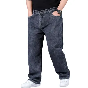 Close-up of men's loose fit straight leg plus size denim jeans in dark grey.