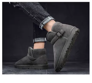 Detailed view of gray suede winter snow boots with buckle strap detail