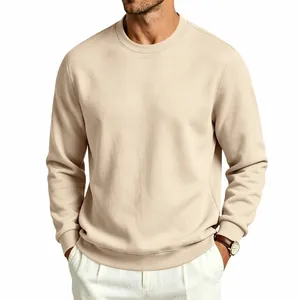 Close-up of the textured beige fabric and ribbed crew neck of the men's sweatshirt.