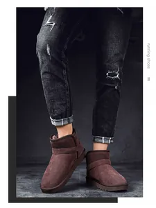 Close-up of model wearing brown suede fur-lined snow boots with black distressed jeans.