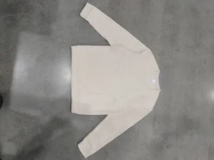 Top-down view of cream men's crewneck fleece sweatshirt featuring loose fit classic design