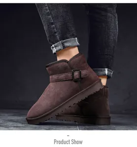 Macro detail of classic brown suede leather snow boots with adjustable buckle strap.