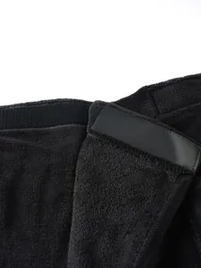 Close-up detail of the durable black Velcro fastener on a wearable plush bath towel