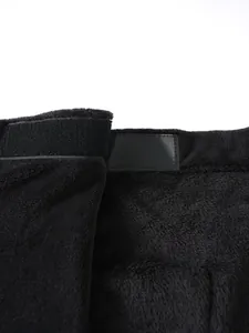 Detailed close-up showing the soft fleece texture and velcro closure of a black wearable towel