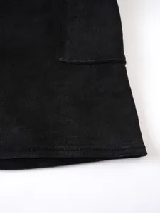 Detailed view of black terry cloth wearable towel showing pocket and soft texture